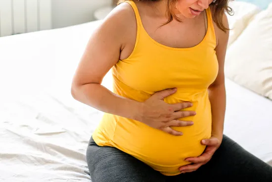 photo of Pregnant woman feeling pain in her stomac