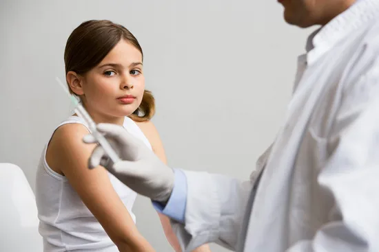 doctor preparing child's vaccine