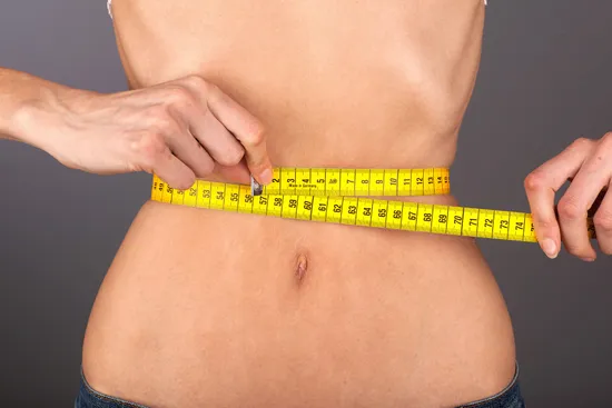 anorexic woman measuring waist