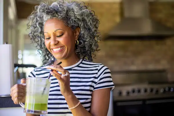 photo of woman drinking smoothie