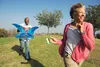 photo of mature couple playing with kite