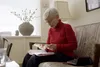 photo of senior woman using reading device