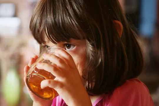 photo of girl drinking apple juice