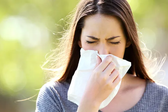 photo of woman outdoors with allergies