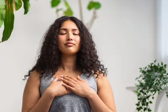 photo of woman doing deep breathing exercise