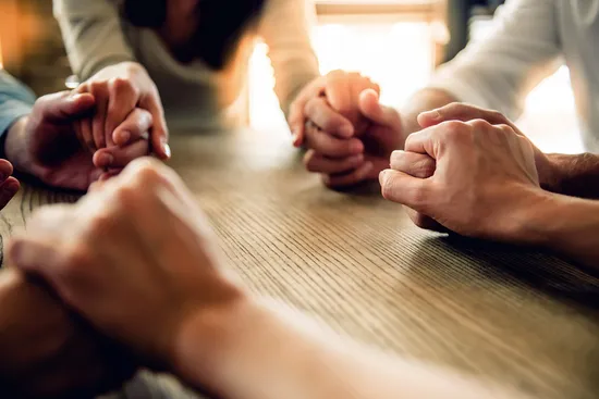 photo of support group holding hands