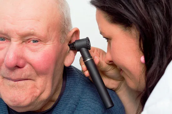 photo of Audiologist checking elderly man