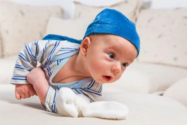Tummy time is an important first step for getting your baby to roll over. Doing tummy time each day will strengthen your baby's muscles to prepare them to roll over and eventually sit up. (Photo credit: Gabriela Insuratelu/Dreamstime)