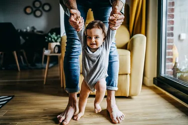 Encourage your baby to explore so they feel safe and confident enough to take their first steps into the world. (Photo Credits: E+/Getty Images)