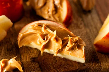 Peanut butter and apple slices make a great high-protein snack. (Photo Credit: Bhofack2/Dreamstime)
