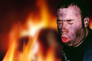Coughing and soot on the face are signs of smoke inhalation, the number one cause of fire deaths. (Photo credit: Gareth Cosgrove/Dreamstime)