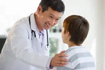 photo of doctor talking with young patient