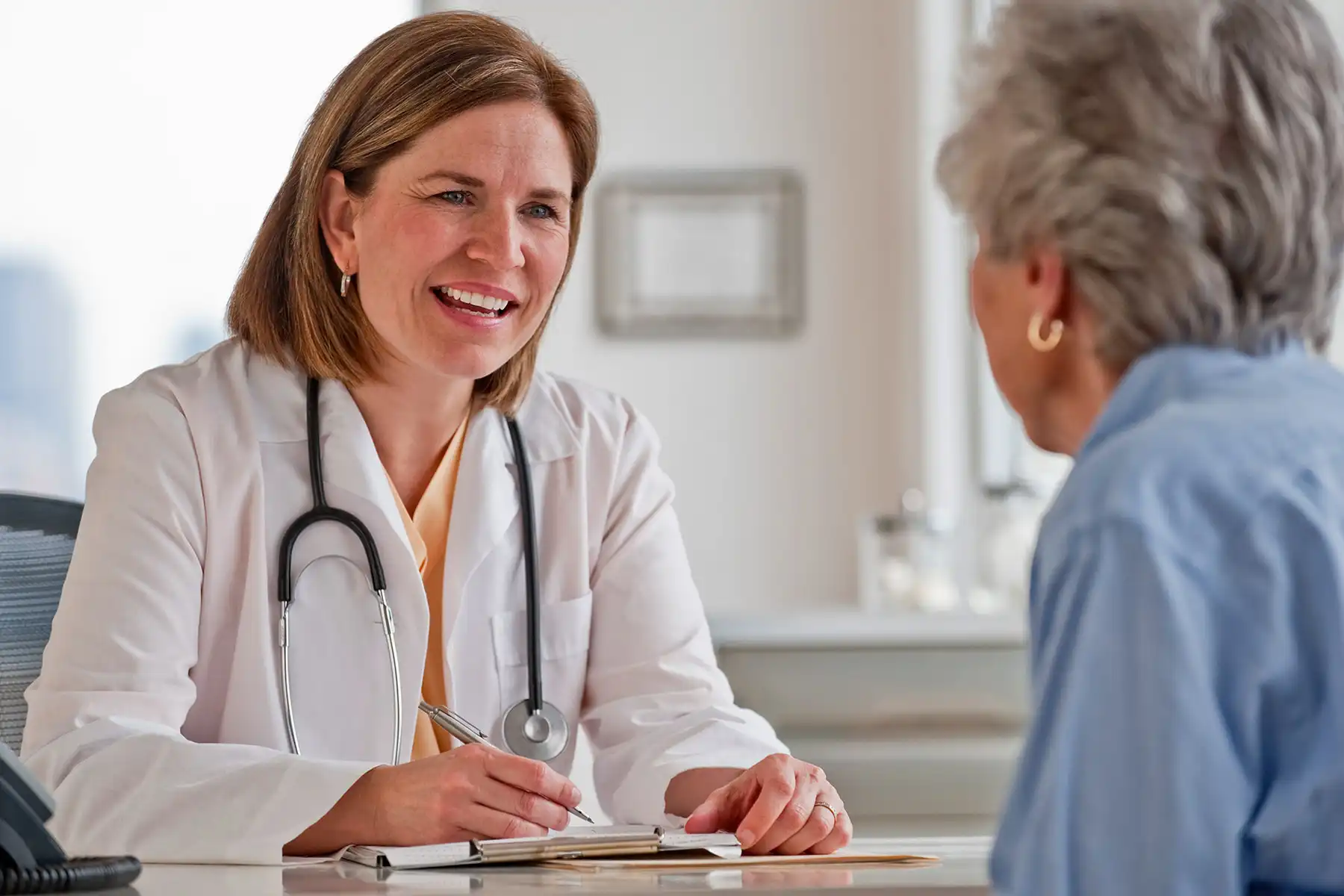 photo of senior woman talking with doctor