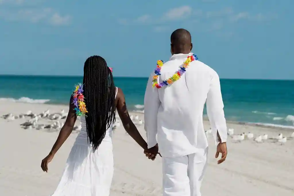 photo of couple holding hands at beach