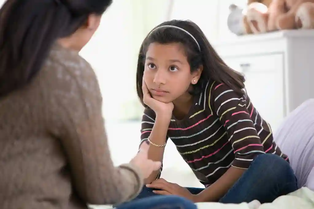 photo of mother talking to daughter