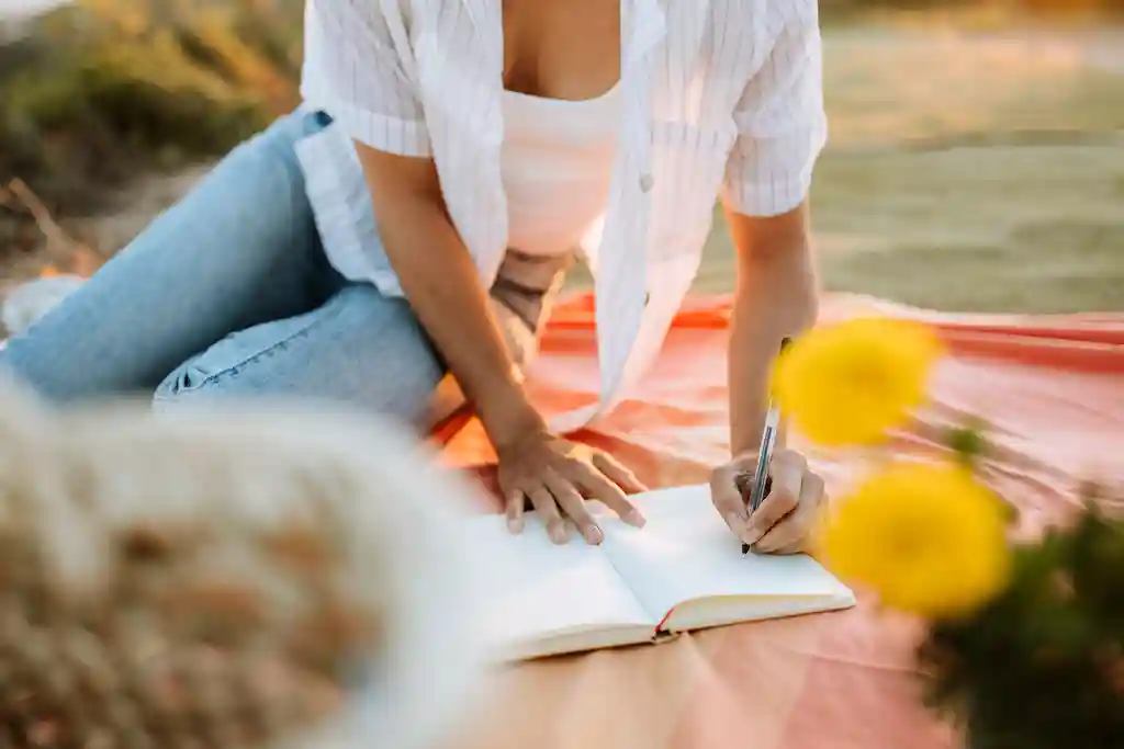 photo of woman writing in journal