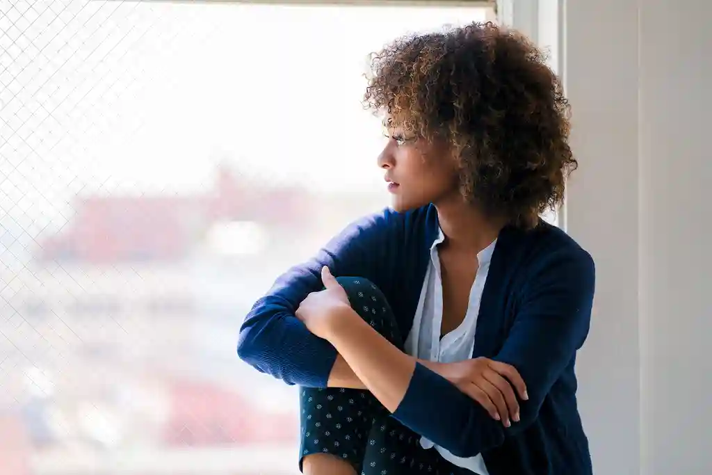 photo of woman looking out window