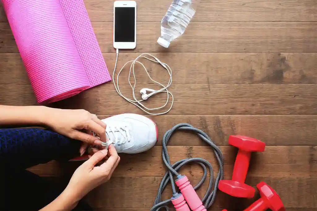 photo of woman tying shoe at gym