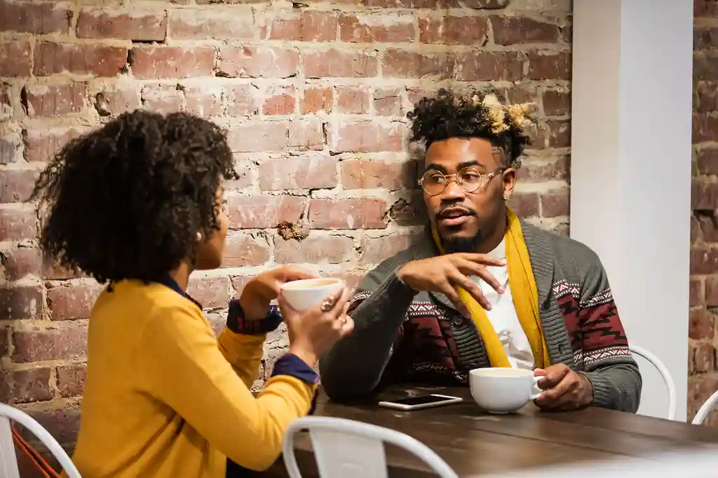 photo of couple talking in coffee shop