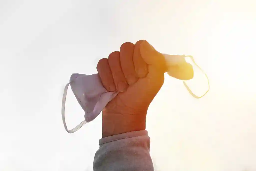 holding up face mask