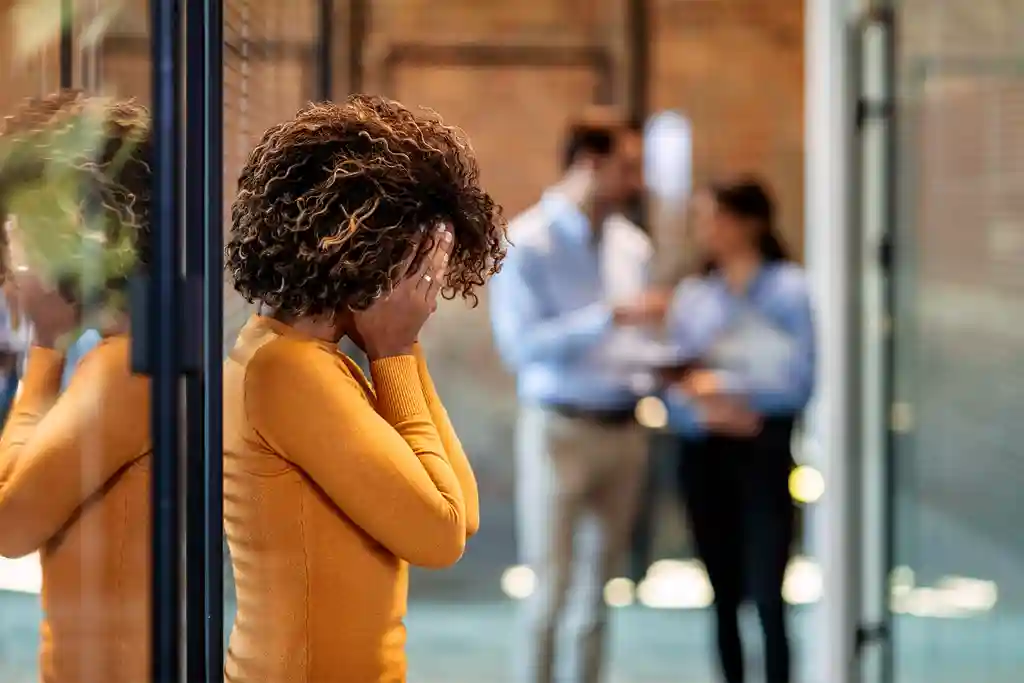 photo of woman in office having a headache