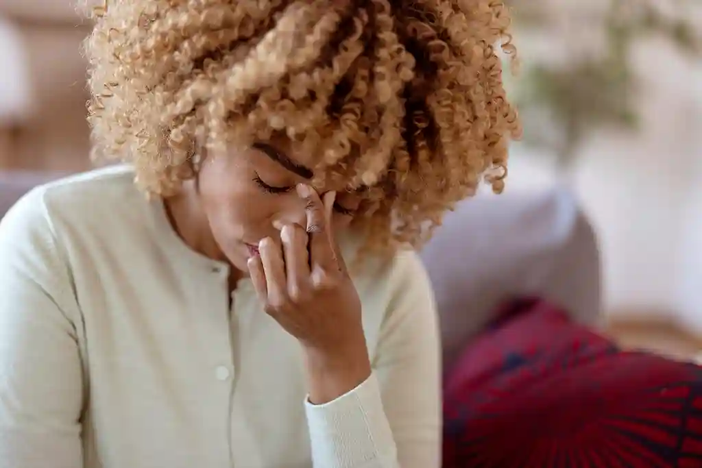 photo of unhappy young woman with migraine