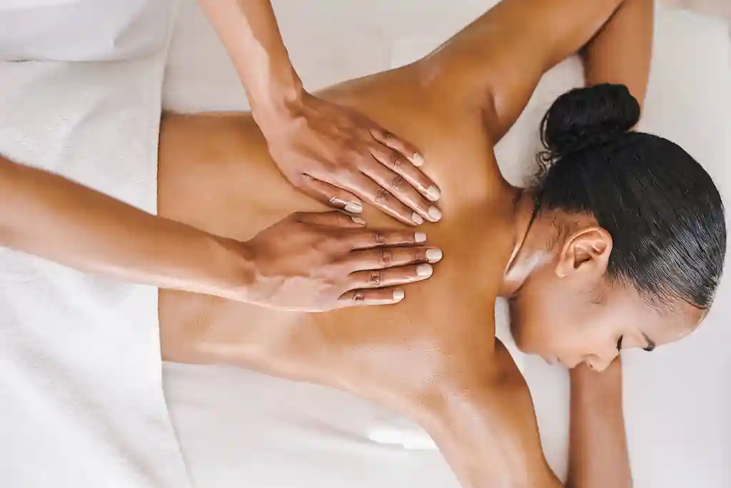 photo of young woman getting a massage at a spa