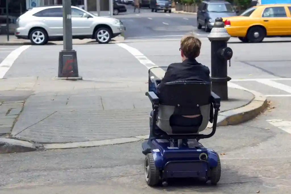 photo of iman crossing street in mobility scooter