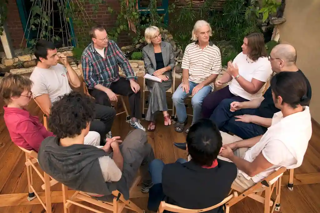 photo of group of people sitting in circle