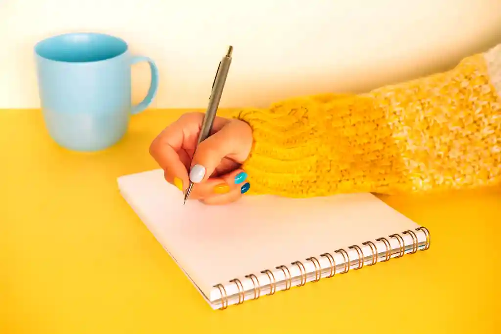 photo of woman writing in journal