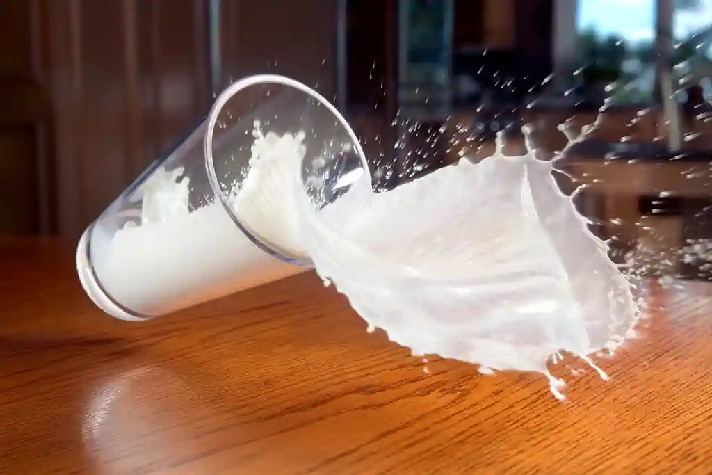 photo of glass of milk spilling
