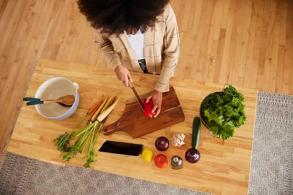 photo of woman cutting vegetables