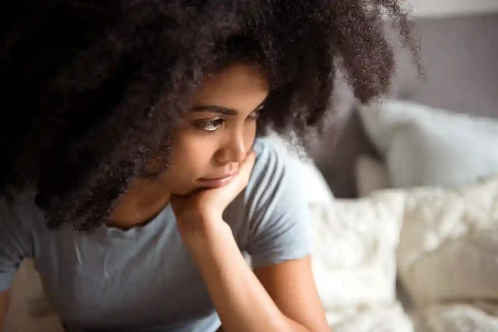 photo of unhappy woman on bed