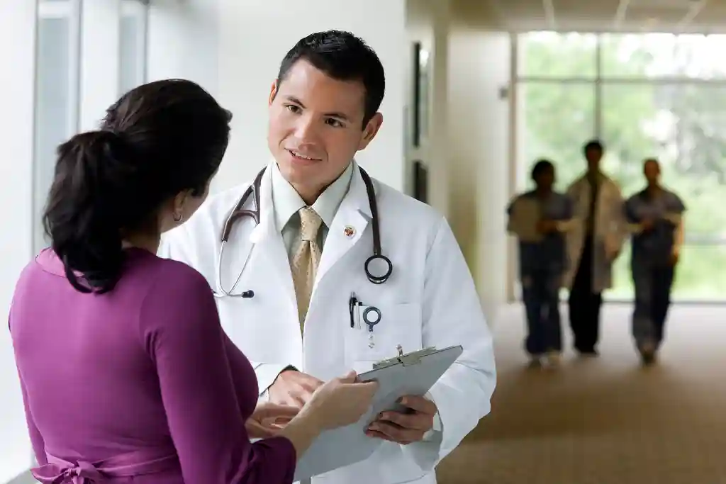 photo of doctor talking with co-worker