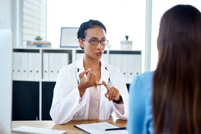 photo of doctor talking with patient