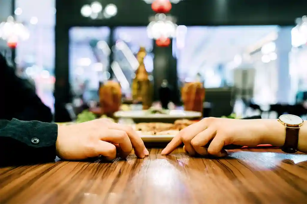 photo of couple attempting to hold hands