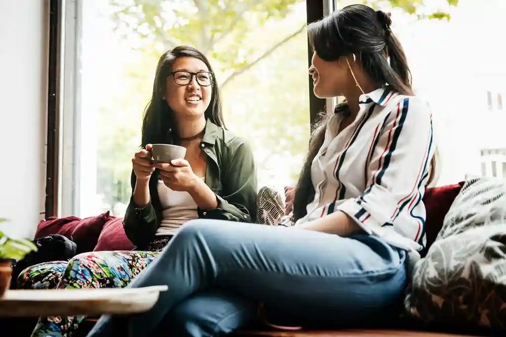 photo of friends talking on couch