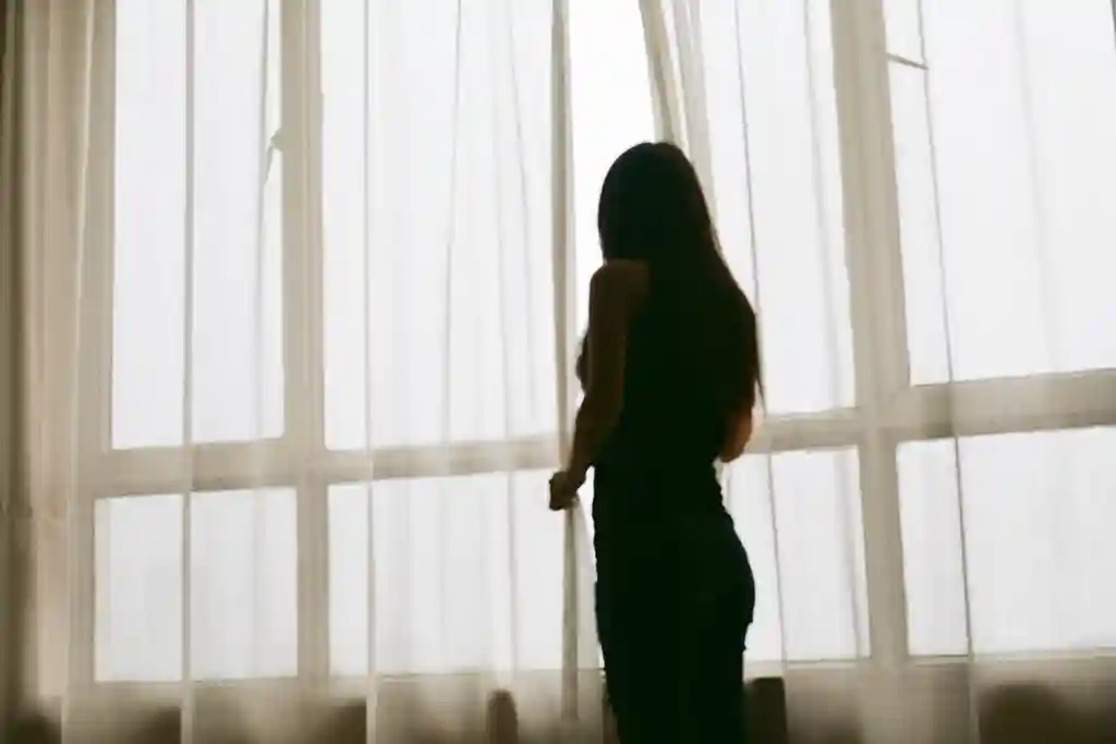 girl standing in front of window