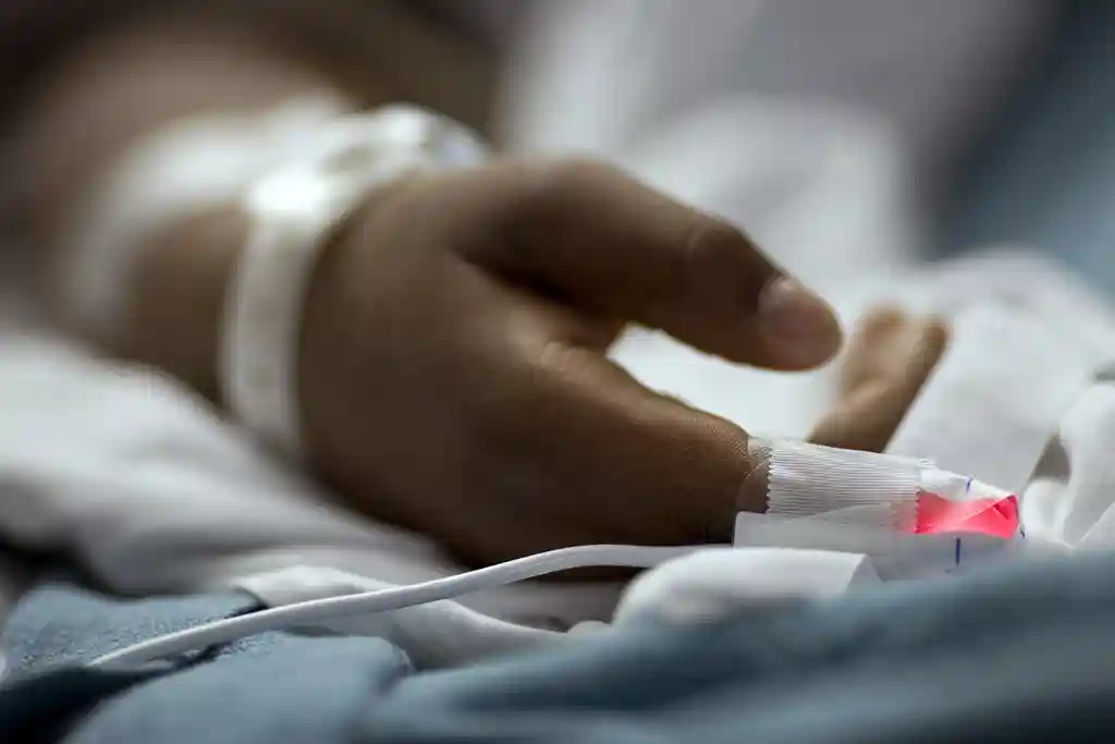 photo of hand of patient in hospital bed