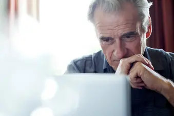 photo of senior man using computer