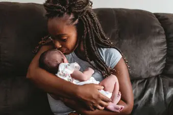 photo of mother soothing baby
