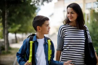 photo of mother and boy walking home