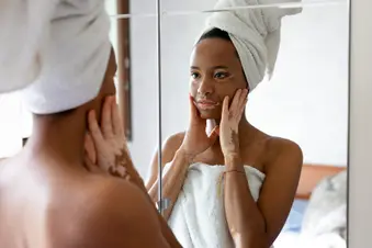 photo of woman with vitiligo looking in mirror