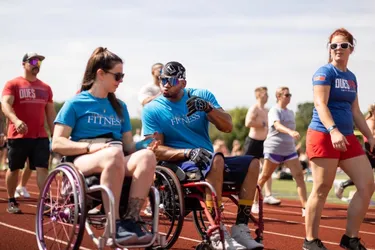 Jesi Stracham, left, connects with a fellow wheelchair road racer.