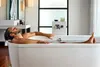 photo of man soaking in bathtub