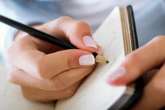 photo of person writing in diary