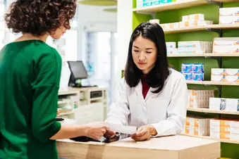 photo of pharmacist and customer at counter