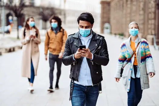 photo of group of people walking and wearing masks