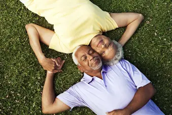photo of couple laying on grass