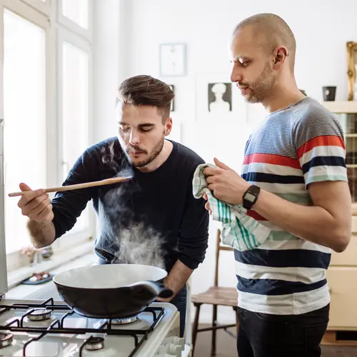 photo of gay couple cooking
